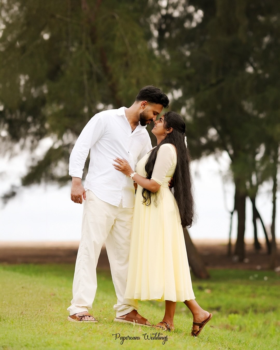 A couple embracing in a green garden
